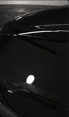 Same panel after hand wax and polish, swirl-free mirror finish