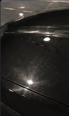 Close-up of car paint before polishing, swirl marks visible