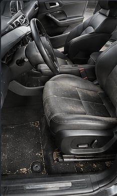 Car interior before detailing, dirt on seats and floor